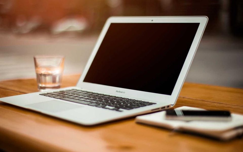 A laptop on a neat wooden desk